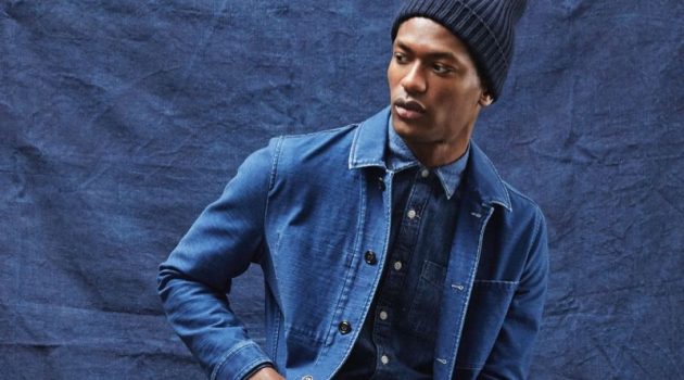 Hamid Onifade dons an indigo Japanese French chore coat and denim button-down shirt from Todd Snyder.