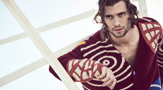 Connecting with Mytheresa for its spring-summer 2021 campaign, David Corenswet wears a chunky cardigan by The Elder Statesman.