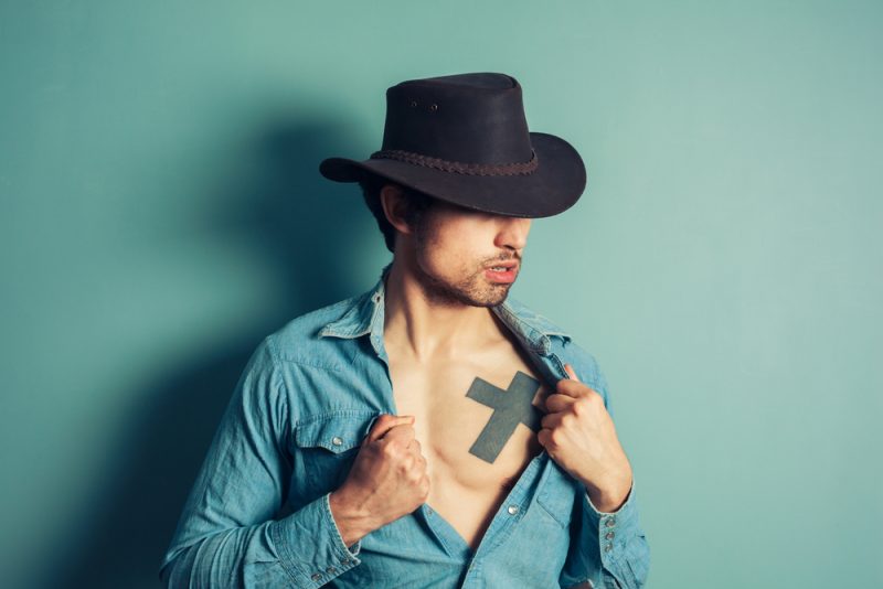 Man with Hat and Tattoo