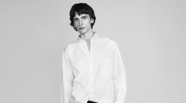 Benno Bulang dons a crisp white band-collar shirt with black trousers for UNIQLO +J's spring 2021 campaign.