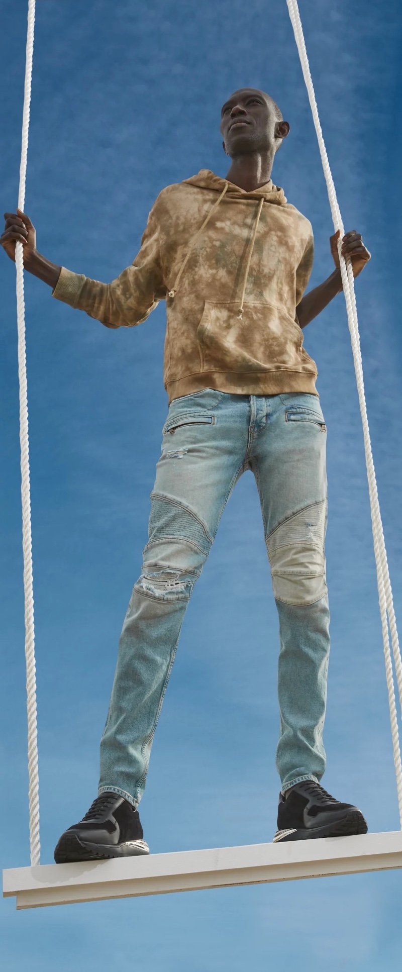 Going casual, Armando Cabral dons denim jeans with a tie-dye hoodie from Hudson Jeans.
