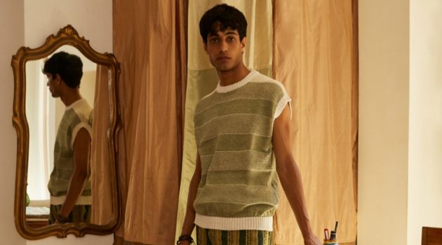 Matteo Tagliabue wears a striped sweater vest and patterned pants from Luca Larenza's spring-summer 2022 collection.