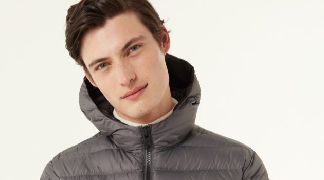 Gabriel Daum stays warm in a Colmar Originals sporty hooded down jacket in grey.