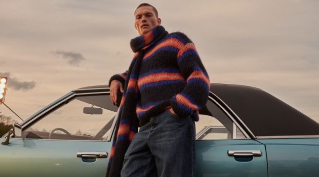 William Los models a matching striped sweater and scarf from Kenzo.