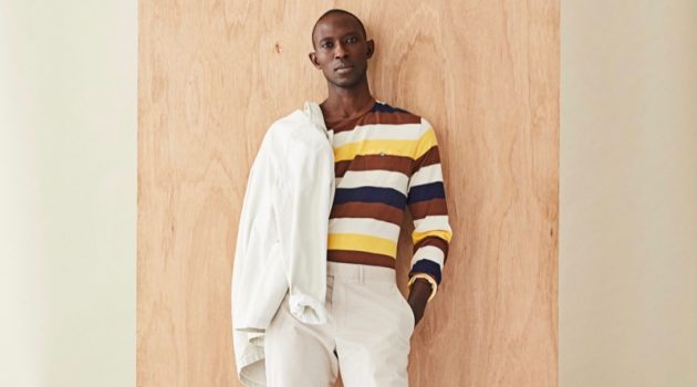 Front and center, Armando Cabral dons a long-sleeve striped pocket tee with a neutral-colored jacket and pants from Todd Snyder.