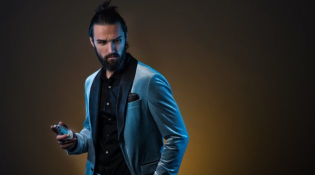 Male Model Blue Suit Holding Fragrance Bottle