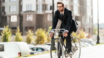 Male Model Wearing Suit Using Bicycle