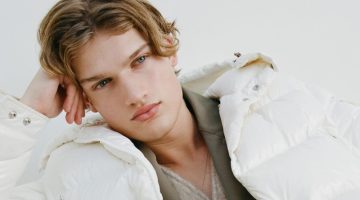 A winter vision in white, Thijs Leushuis wears a hooded feather down jacket by Moncler.