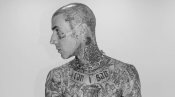 Posing shirtless, Travis Barker not only shows off his body of tattoos but his new jewelry designs for Clocks + Colours.