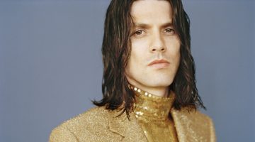 Shining in a gold sequin top and shimmering blazer, James Bay appears in Man About Town.