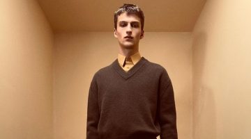 Vasko Luyckx wears a wool v-neck sweater over a shirt and shorts from the Zara Edition spring-summer 2023 collection.