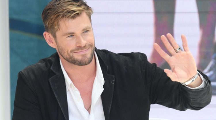 Chris Hemsworth waves, revealing a glimpse at his wedding band. Photo: ChinaImages / Shutterstock