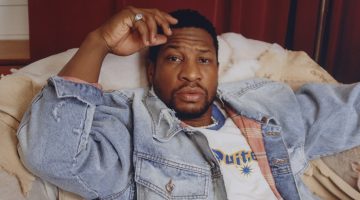 Jonathan Majors wears an Enfants Riches Déprimés denim trucker jacket with a Polite Worldwide t-shirt, OrSlow jeans, and a Hatton Labs necklace.