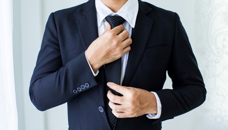 Man Suit Adjusting Tie
