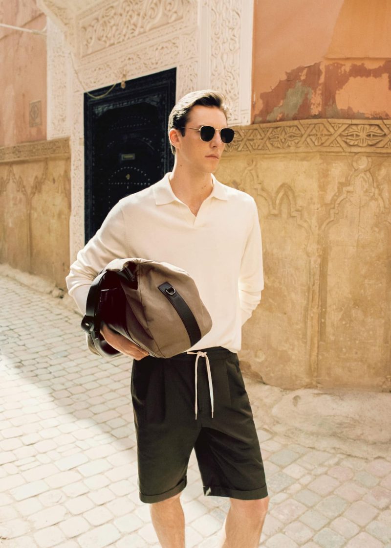 Connecting with Mango, Quentin Demeester is a chic vision in a long-sleeve polo and tailored cuffed shorts.