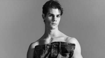 Leonardo Tano sports Emporio Armani underwear briefs as he holds a pair of the label's essential jeans.