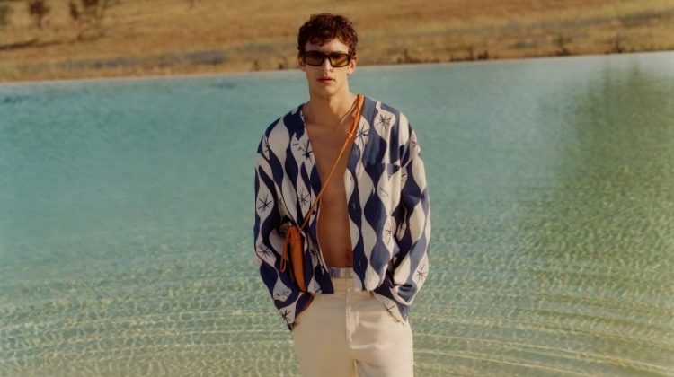 Habib Masovic wears a wave print overshirt and regular-fit jeans from "The Summer Escape" Zara collection.