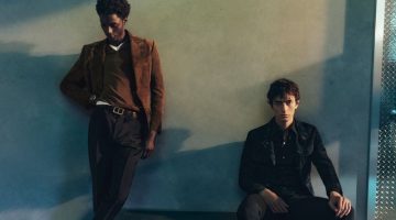 Models Ahmed Richards and Gena Malinin don neutral-colored tailoring for Tom Ford's pre-fall 2023 campaign.