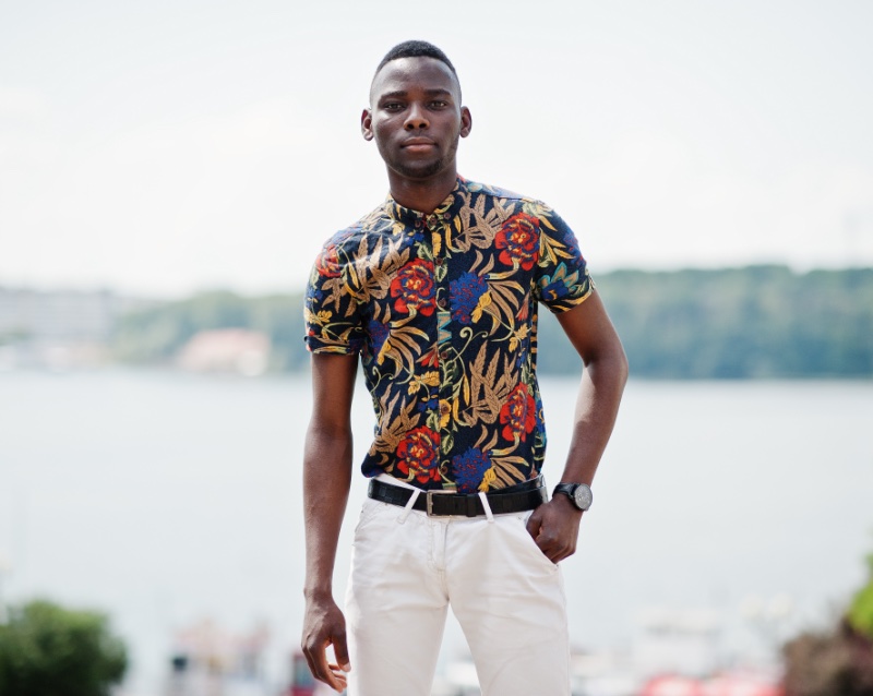 Man in white crew neck t-shirt and white pants standing near brown wall  photo – Free Blackman Image on Unsplash
