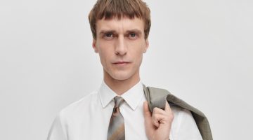 Dressed for business, Clément Chabernaud wears The Kensington grey and brown mini check wool suit with a brown silk ombre stripe tie by Paul Smith.