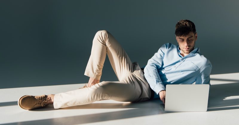 Man Looking at Laptop Studio Featured