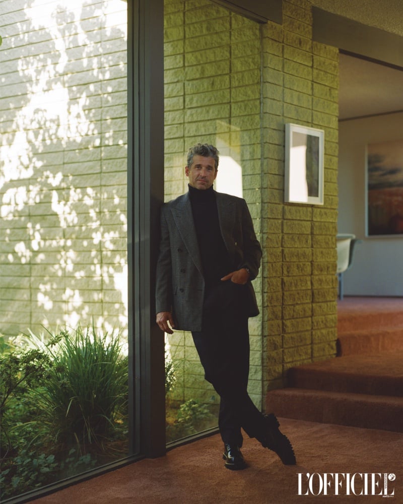 Patrick Dempsey stands poised, his sophisticated style harmonizing with the natural light and modern architecture around him.
