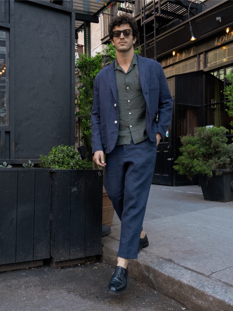 Dressed up, Raphael Diogo models an Alex Mill camp shirt with a linen blazer and pleated pants. 