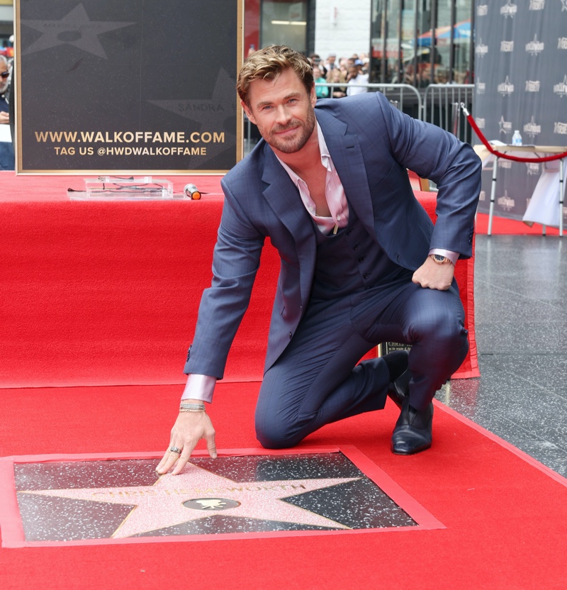 Chris Hemsworth poses with his new star on the Hollywood Walk of Fame.
