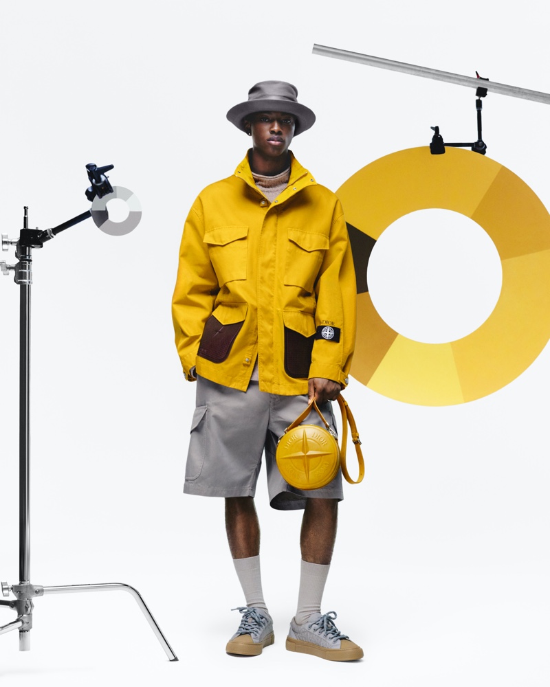 Nonso Ojukwu stands out in a yellow and gray fit from the Dior and Stone Island collection. 