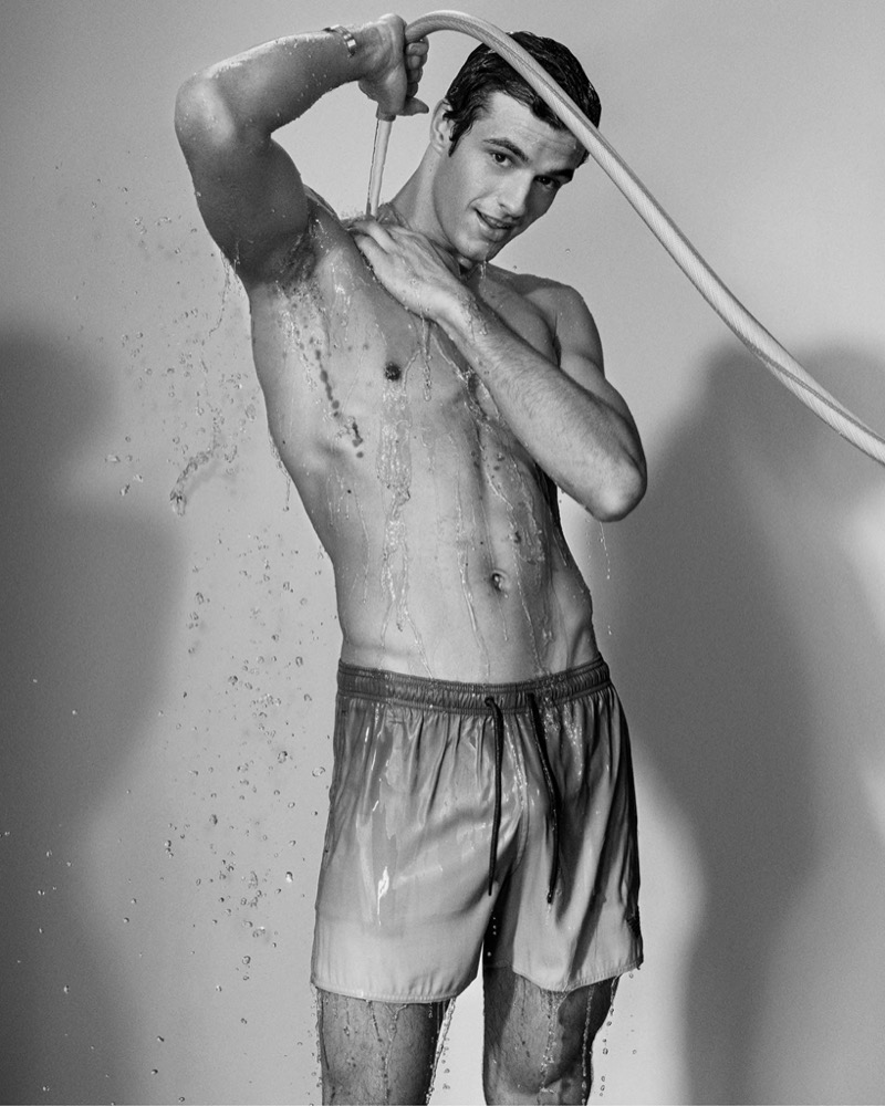 Francesco Ruggiero wears swim shorts from Emporio Armani's summer 2024 beachwear collection. 