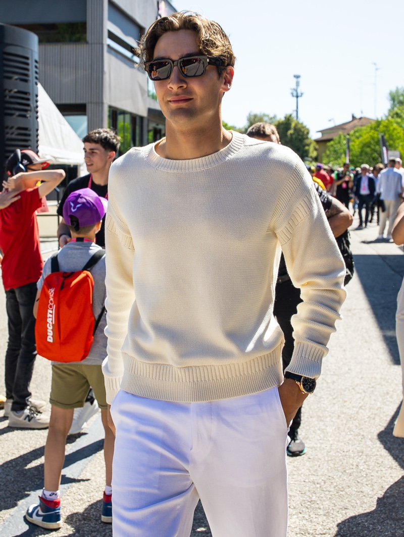 George Russell is a chic vision in a sweater and white linen trousers at the Emilia Romagna Grand Prix.