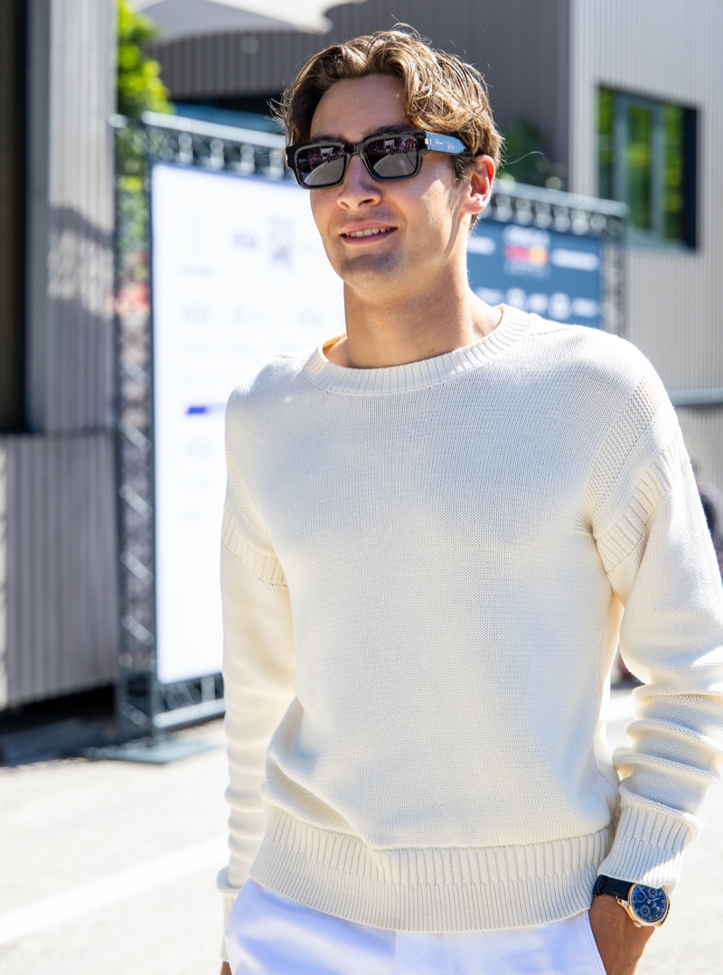 George Russell sports a cream-colored sweater with linen trousers by Tommy Hilfiger at the Emilia Romagna Grand Prix. 