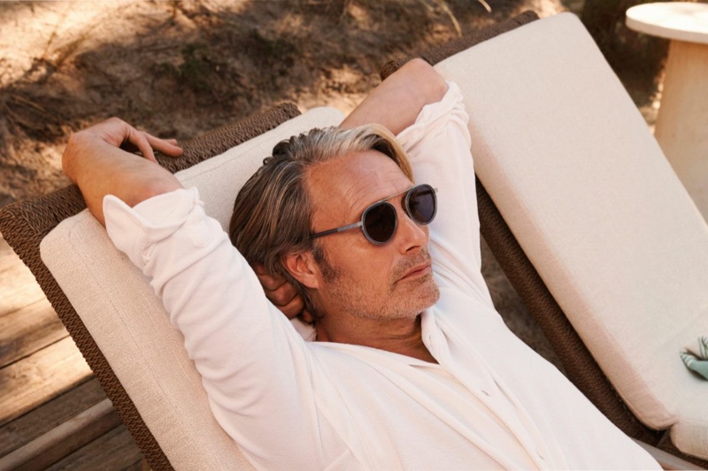 Zegna brand ambassador Mads Mikkelsen soaks in the sun for the summer 2024 Oasi Lino campaign.