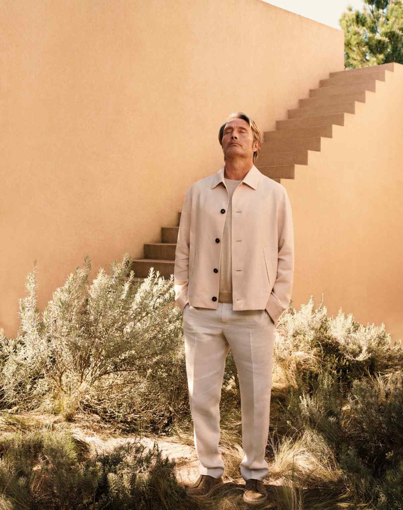 Actor Mads Mikkelsen sports a chore jacket with linen trousers for Zegna's summer 2024 Oasi Lino campaign.