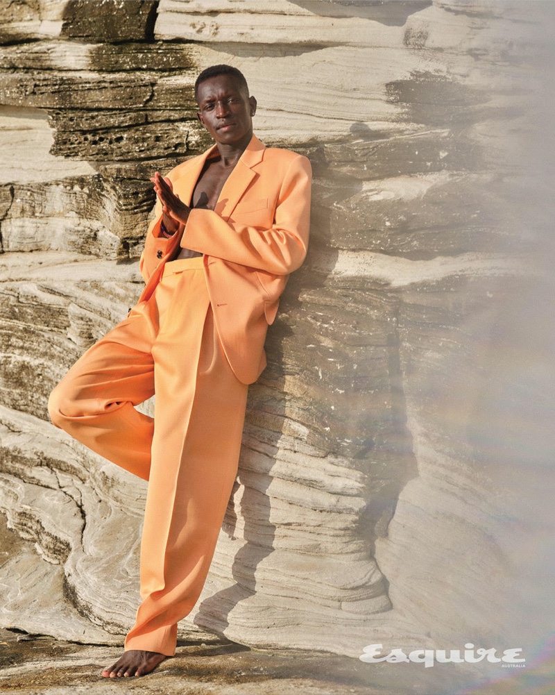Making a statement in orange, Peter Bol sports a Bottega Veneta suit.