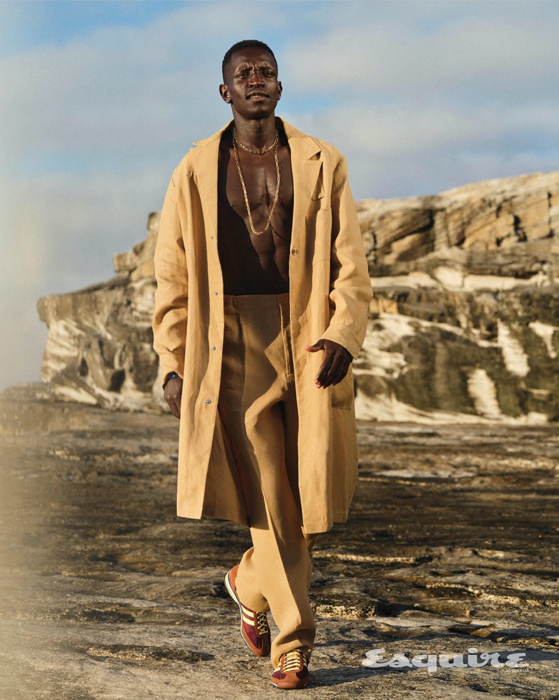 Peter Bol wears a Fendi coat and pants with adidas shoes. He also dons necklaces by Brie Leon and Alinka.