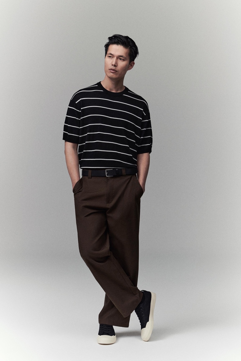 Dae Na models a striped knit t-shirt with brown trousers by Zara.