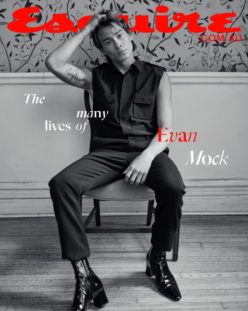 On the digital cover of Esquire Australia, Evan Mock lounges in a sleeveless shirt and patent leather boots, wearing Saint Laurent. 
