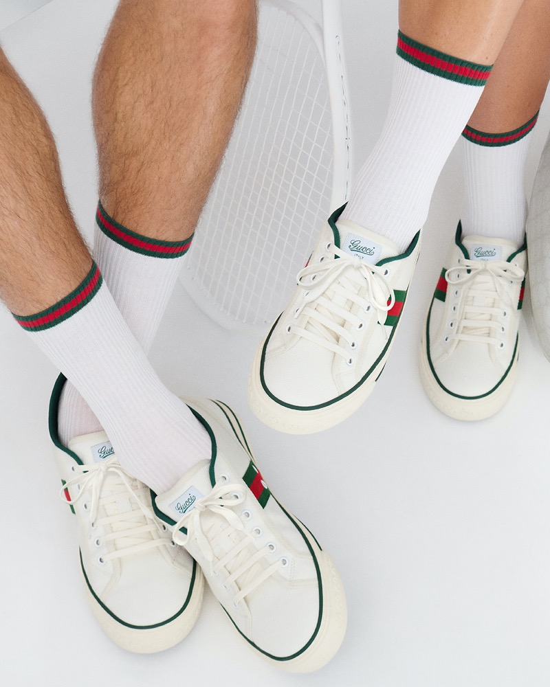 Gucci's tennis collection features sleek white sneakers with its red and green web.