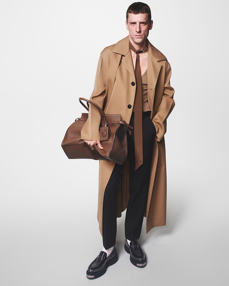 George Barnett embodies classic sophistication in a camel trench coat and polished accessories for Gucci's fall-winter 2024 campaign. 