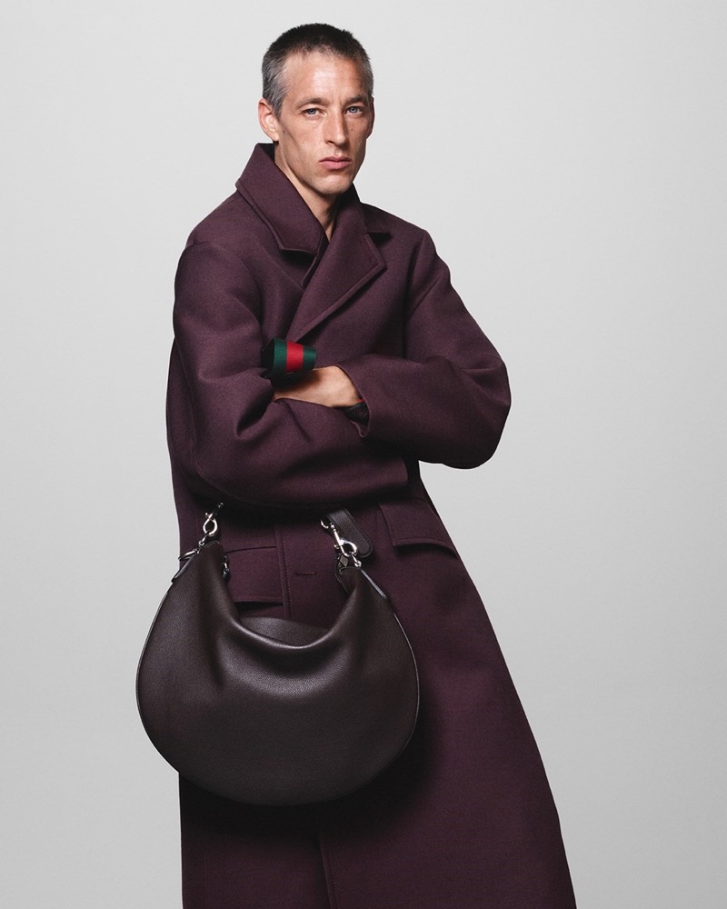 Joel Frampton exudes understated luxury in a deep plum coat for Gucci's fall-