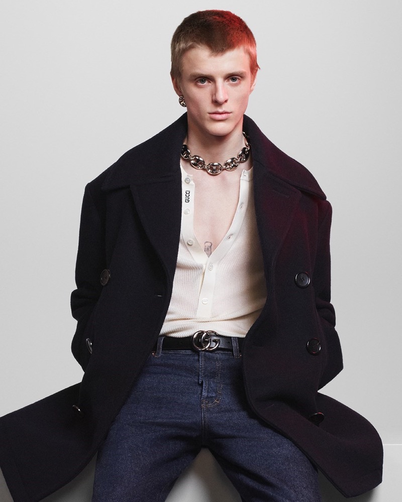 Finn Collins mixes edgy and classic elements in a dark overcoat and statement accessories for Gucci's fall-winter 2024 campaign.