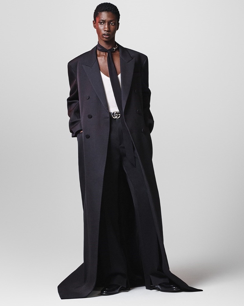 Douta Sidibe commands attention in an oversized tailored suit with dramatic lines for Gucci's fall-winter 2024 campaign. 