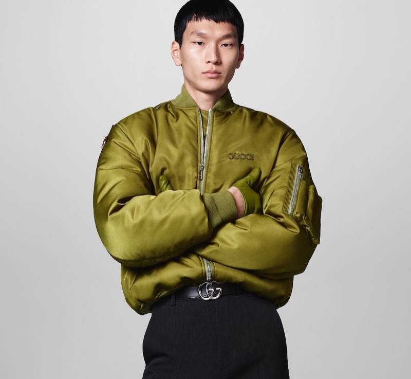 Junyeong Baek sports an olive bomber jacket with classic black trousers for Gucci's fall-winter 2024 campaign.