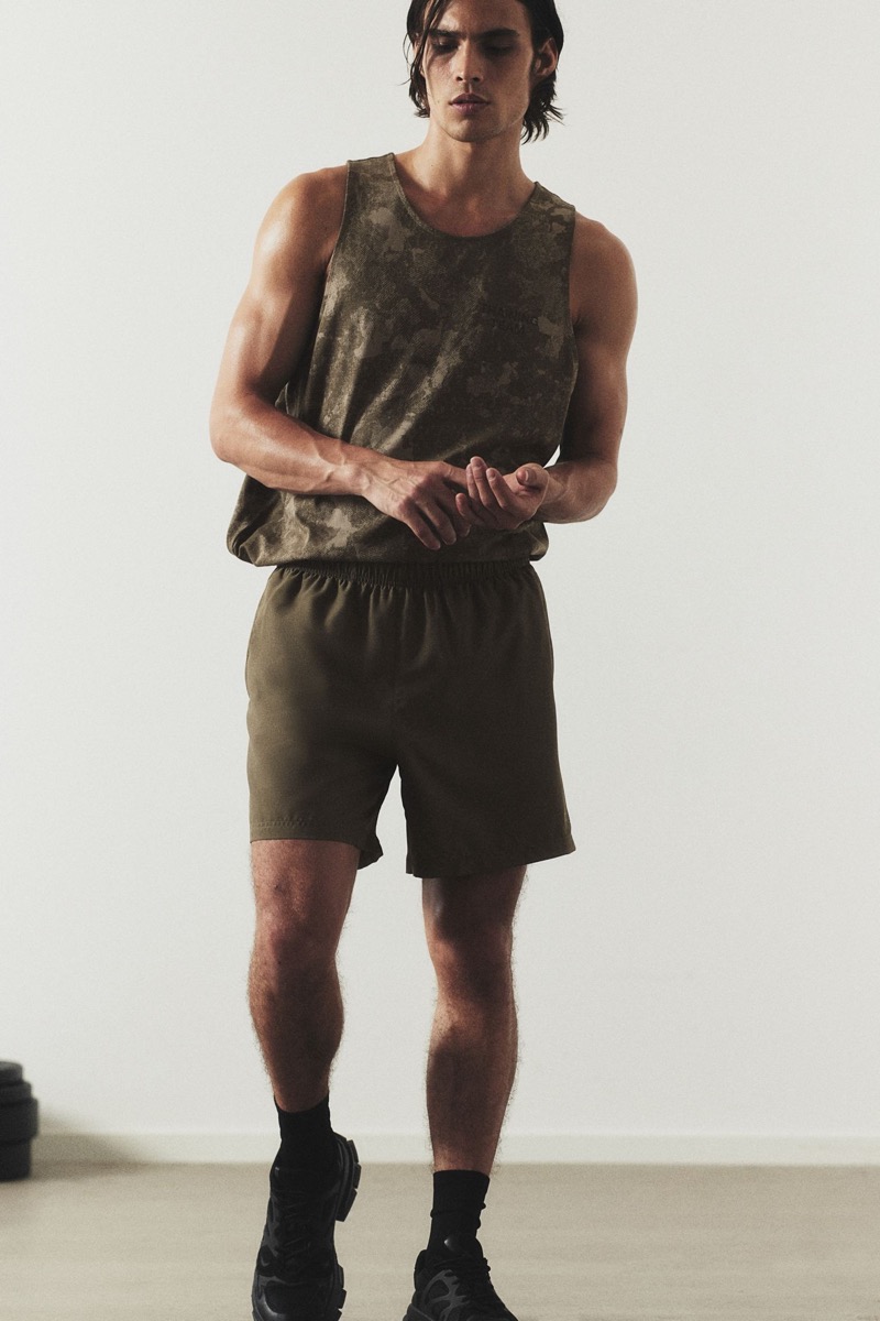 Going sporty, Louis Baines wears an H&M DryMove patterned tank and woven sports shorts. 