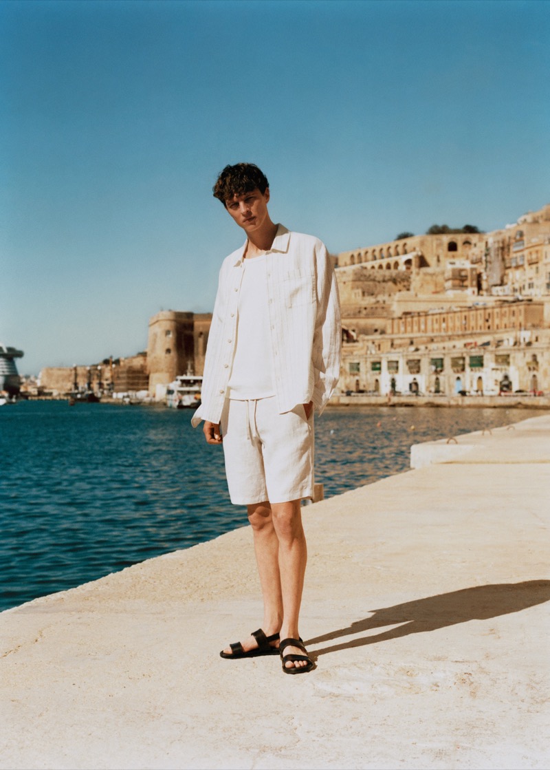 Tim Schuhmacher stands tall against the backdrop of Malta, epitomizing casual cool in Mango's summer 2024 attire. 