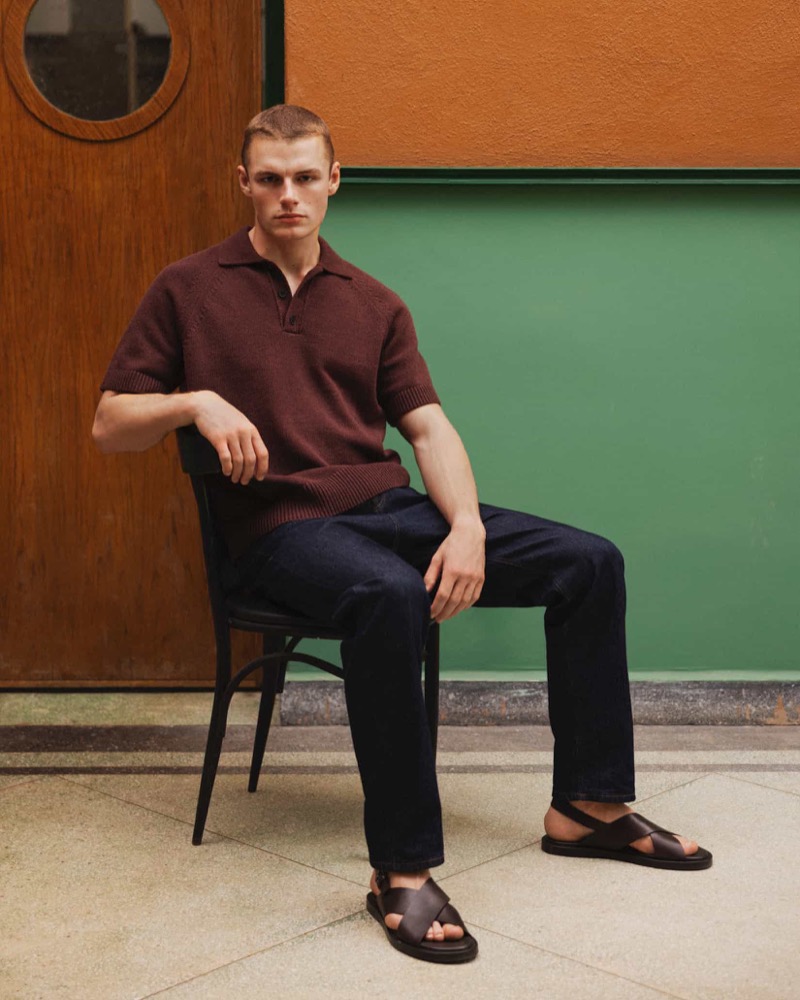 Finley Prentice wears Massimo Dutti, showcasing a maroon polo paired with dark denim and leather cross-strap sandals.