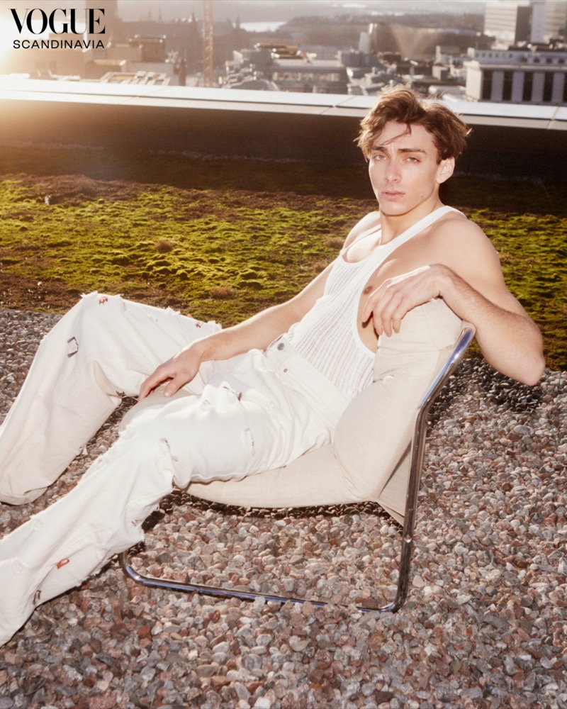 Mondo Duplantis relaxes in a white Isabel Marant outfit against an urban backdrop for Vogue Scandinavia.
