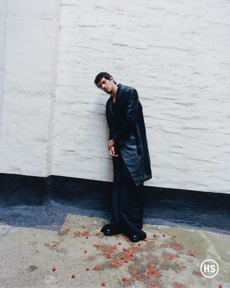 Singer Omar Apollo leans against a stark wall in Rick Owens and Calvin Klein.