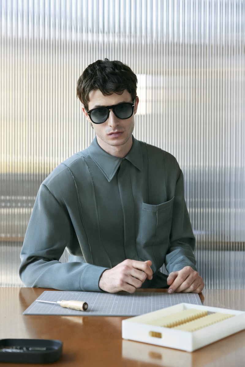 Model Oscar Kindelan embodies modern sophistication in Persol's black 649 Iron sunglasses. 